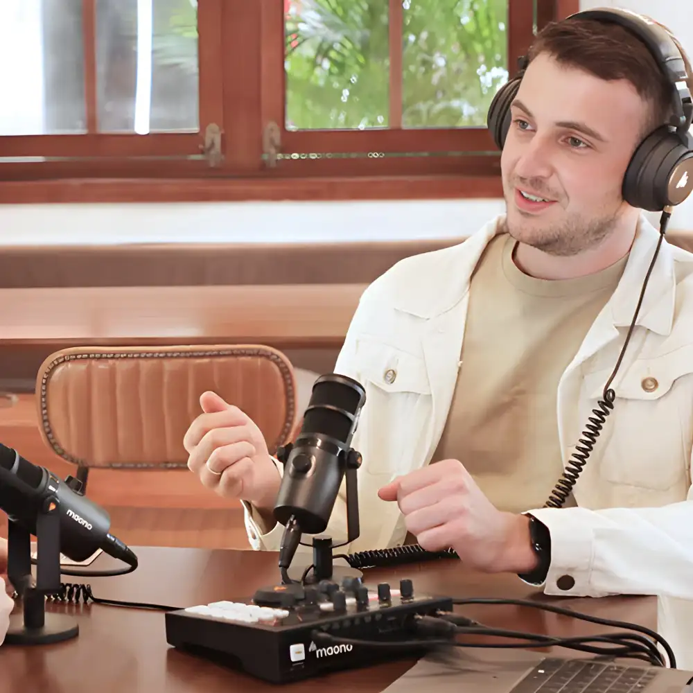 A desk setup image showing the PD400X mounted on a stand beside a laptop,