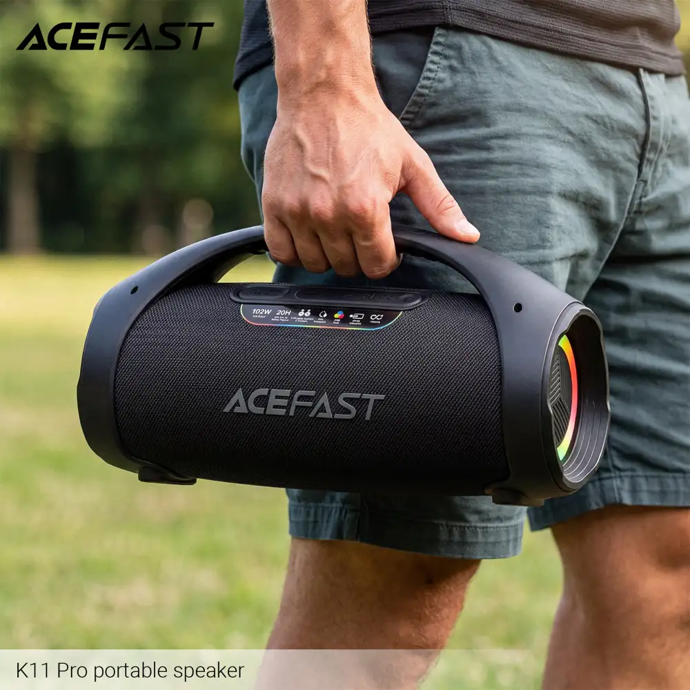 ACEFAST K11 Pro 102W portable Bluetooth speaker being carried outdoors with IPX5 waterproof design and powerful wireless audio